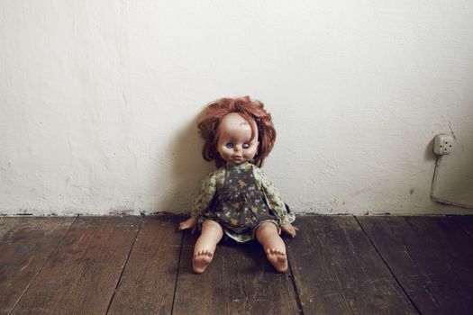 Creepy Vintage Doll on wooden floor