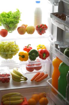 close up of a refrigerator full of fruits and vegetables
