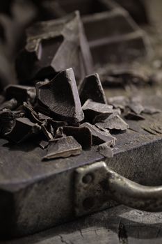 Pieces of dark chocolate  on a wooden background