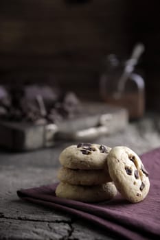 Stack of chocolate chip cookies with ingredients in the background