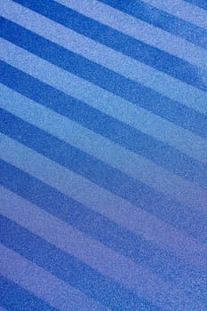 A blue striped background with the stripes going across this vertical image in a diagonal way.