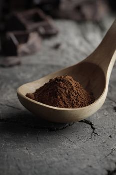 Wooden spoon full of cocoa powder