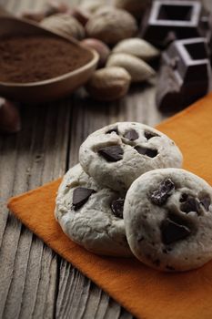 Chocolate chip cookies with ingredients in the background