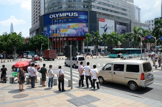 SHENZHEN, CHINA - SEPTEMBER 6: Unidentified group of people walk along HuaQiang Lu - famous shopping street in Shenzhen on September 6, 2012.