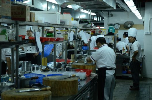 SHENZHEN, CHINA - SEPTEMBER 8: Unidentified Chinese chefs work in kitchen, inside Cantonese style restaurant in Nanshan district on September 8, 2012.