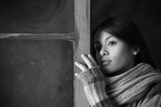 Portrait of a beautiful woman at window 