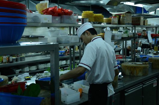 SHENZHEN, CHINA - SEPTEMBER 8: Unidentified Chinese chefs work in kitchen, inside Cantonese style restaurant in Nanshan district on September 8, 2012.