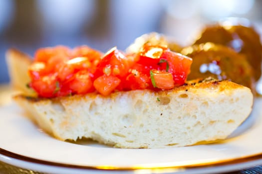 Tomato bruschetta covers this hearty bread as an appetizer at a wedding reception.