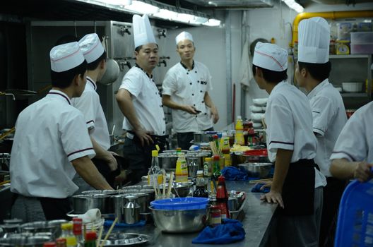 SHENZHEN, CHINA - SEPTEMBER 8: Unidentified Chinese chefs work in kitchen, inside Cantonese style restaurant in Nanshan district on September 8, 2012.