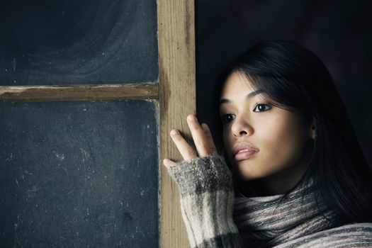 Portrait of a beautiful girl at window 