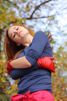 portrait of a beautiful red-headed girl posing outdoors