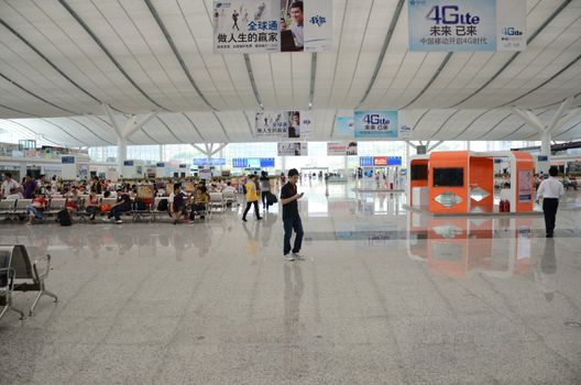 SHENZHEN, CHINA - SEPTEMBER 9:  Unidentified passangers wait inside newly built Shenzhen North station on September 9, 2012. Modern station designed for fast railway.