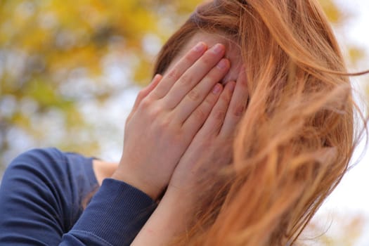 Portrait of a beautiful redhead girl smiling outdoors