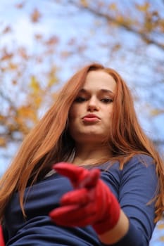 portrait of a beautiful red-headed girl posing outdoors