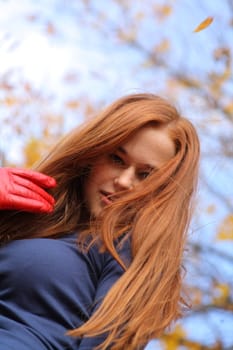 portrait of a beautiful red-headed girl posing outdoors