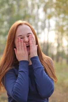 Attractive redhead in autumn having fun