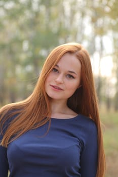 Natural beautiful red-haired girl head and shoulders shot outdoor