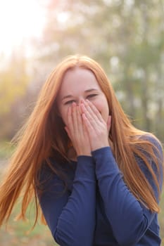 Attractive redhead in autumn having fun