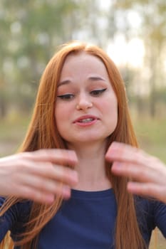 Attractive redhead in autumn having fun