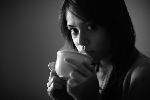 Portrait of beautiful girl drinking a hot drink