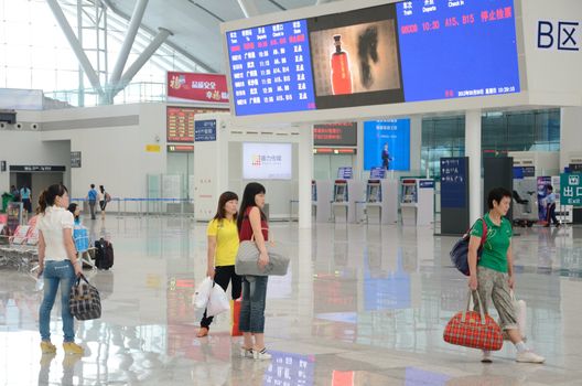 SHENZHEN, CHINA - SEPTEMBER 9:  Unidentified passangers wait inside newly built Shenzhen North station on September 9, 2012. Modern station designed for fast railway.