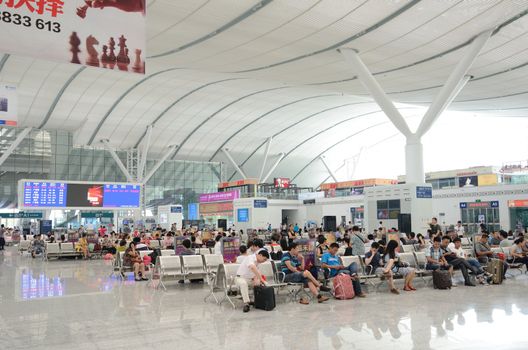 SHENZHEN, CHINA - SEPTEMBER 9:  Unidentified passangers wait inside newly built Shenzhen North station on September 9, 2012. Modern station designed for fast railway.