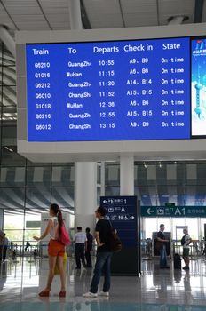 SHENZHEN, CHINA - SEPTEMBER 9:  Unidentified passangers wait inside newly built Shenzhen North station on September 9, 2012. Modern station designed for fast railway.