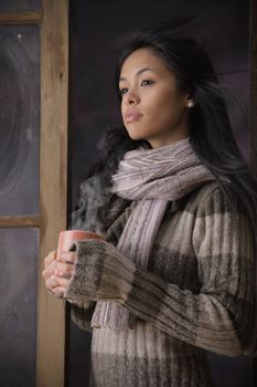 Portrait of a beautiful woman with a cup of coffee or tea