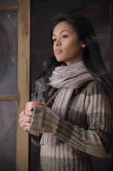 Portrait of a beautiful woman with a cup of coffee or tea