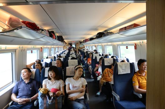 CHINA - SEPTEMBER 9:  Unidentified passangers travel inside fast train between Shenzhen and Wuhan cities on September 9, 2012. 