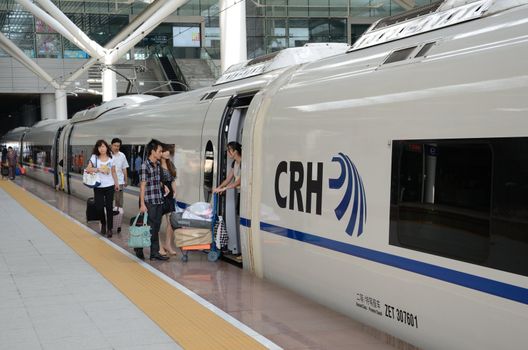 SHENZHEN, CHINA - SEPTEMBER 9:  Fast train in Shenzhen platform. Unidentified passangers board on September 9, 2012. With speed 300km/h train arrives Wuhan within 5 hours.