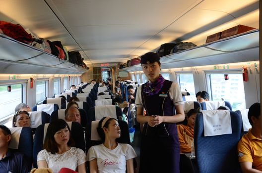 CHINA - SEPTEMBER 9:  Unidentified passangers travel inside fast train between Shenzhen and Wuhan cities on September 9, 2012. 