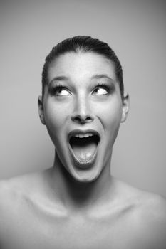 Portrait of beautiful surprised woman looking up