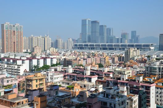 SHENZHEN, CHINA - SEPTEMBER 16:  Modern Shenzhen city, Futian district with old residential buildings and new exhibition center on September 16, 2012. Within 30 years Shenzhen became modern business metropolis.