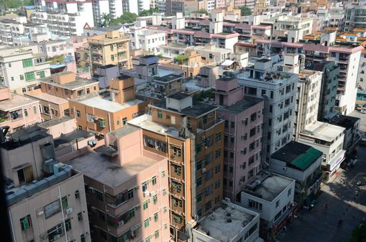 SHENZHEN, CHINA - SEPTEMBER 16:  Modern Shenzhen city, Futian district with old residential buildings on September 16, 2012. Within few years old houses will be replaced with modern skyscrapers.