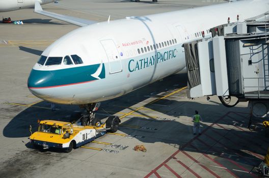 HONG KONG, CHINA - SEPTEMBER 17:  Cathay Pacific plane waits in Hong Kong International Airport on September 17, 2012. Cathay Pacific connects Hong Kong with 42 countries.