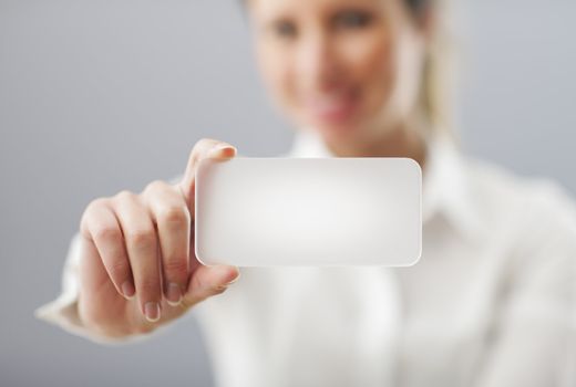 Businesswoman showing his business card. Shallow depth of field - focus on fingers and card. You can just add your text there.