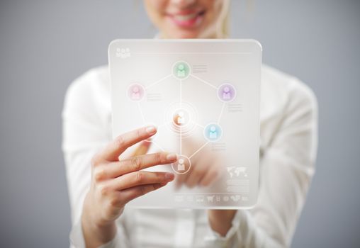 Young smiling woman using tablet computer for social networking and connecting with friends. Elements of this image furnished by NASA