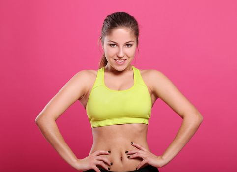 Attractive and sexy fitness girl over a purple background