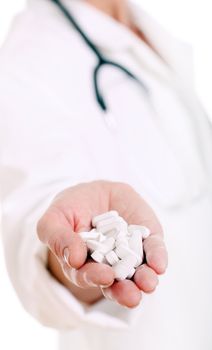 Close up of doc hand holding pills isolated on a white