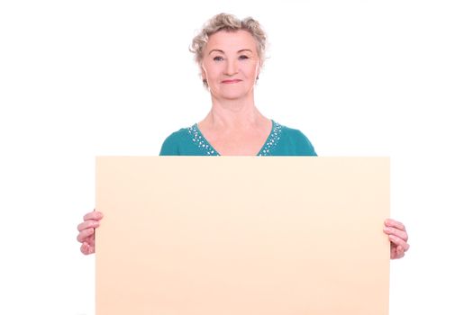 Smiling granny with emty poster in hands over a white background