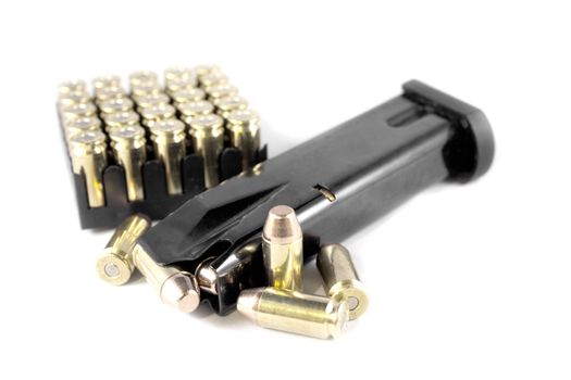 Handgun clip and bullets isolated on a white background