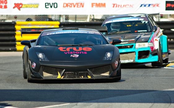 BANG SAEN - DECEMBER 22: Car 78, a black Lamborghini Gallardo, with number 77, the Mitsubishi EVO VI of Krann Suppapong following behind, during the 2012 Bang Saen Speed Festival in Thailand on December 22, 2012.