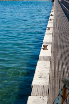 Mooring bollards in a port harbour with clear sea water - marine background image