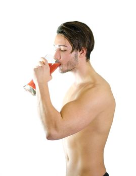No more beer! Shirtless and muscular young man drinking fruit juice from big glass