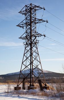 Metal support power lines against the blue sky. Russia. Monchegorsk.