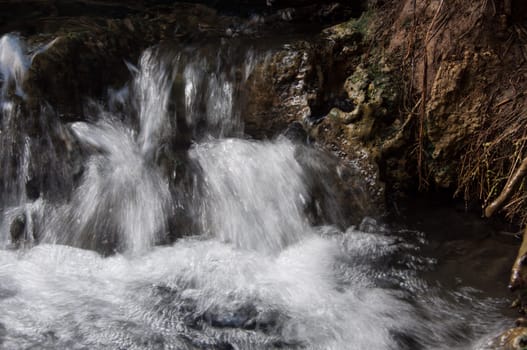 nature flow of water at hot waterfall in krabi, thailand