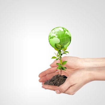 Globe in human hand against blue sky. Environmental protection concept.