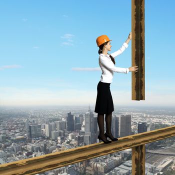 Business woman standing high over a cityscape