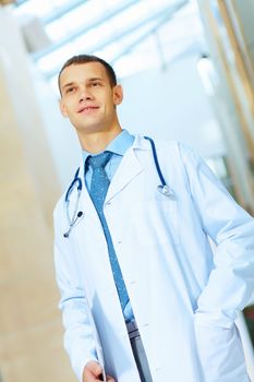 Portrait of friendly male doctor in hospital smiling